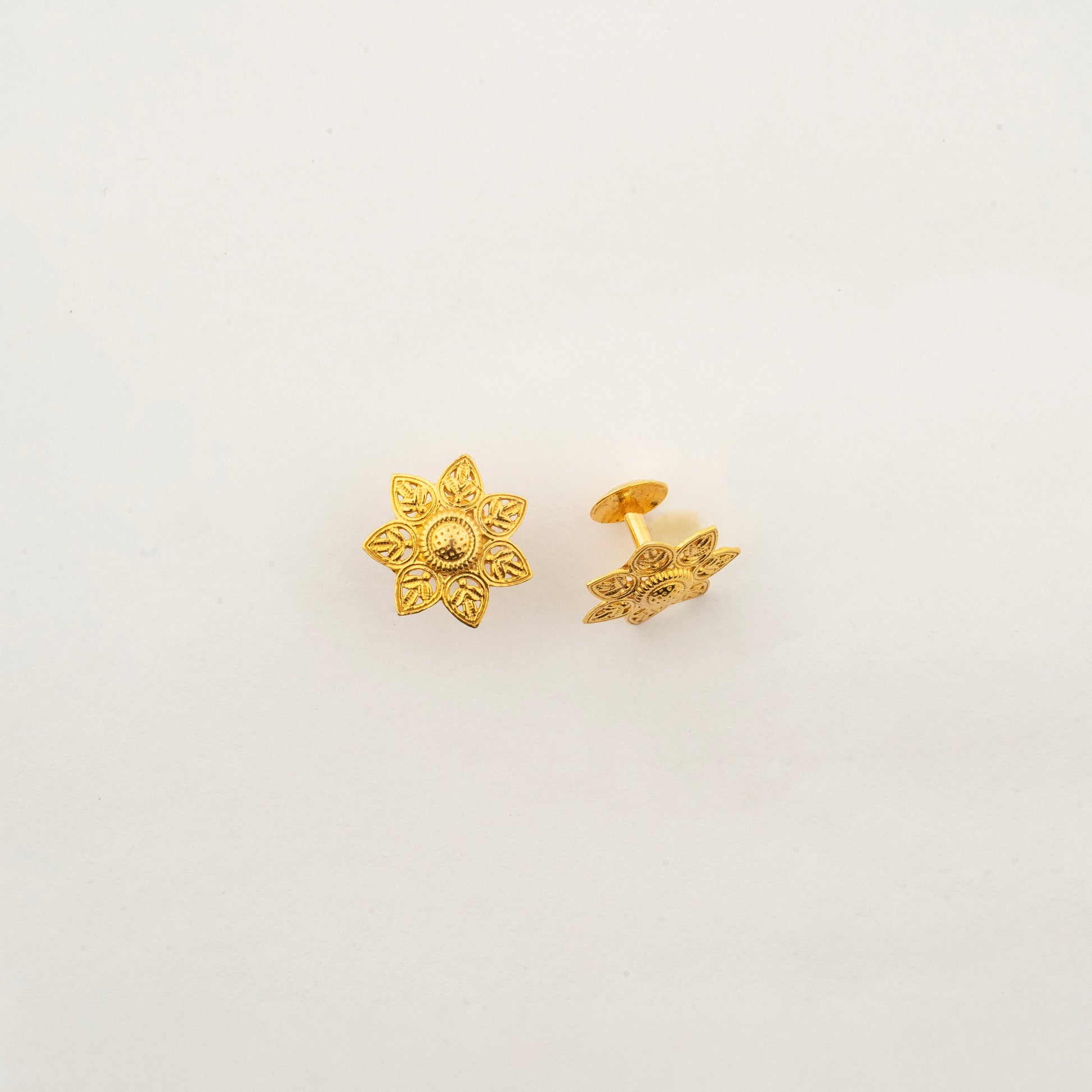 Sculptyx Verdelis Six handcrafted 18K gold botanical leaf stud earrings featuring six sculpted petals inspired by natural foliage.