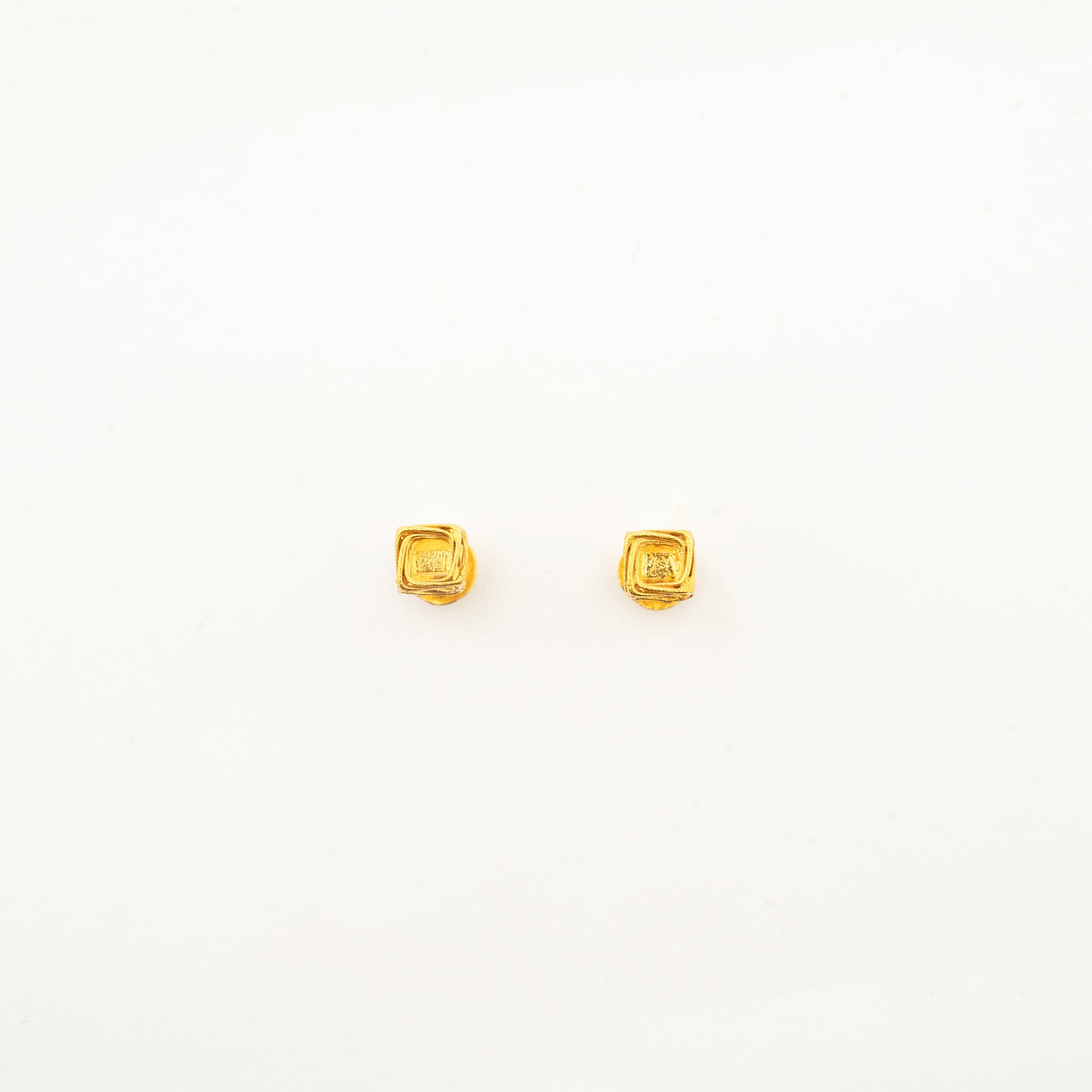 Pair of handcrafted Vertex Vault 18K Pair of handcrafted Vertex Vault 18K gold stud earrings displaying a modern geometric minimalist aesthetic.