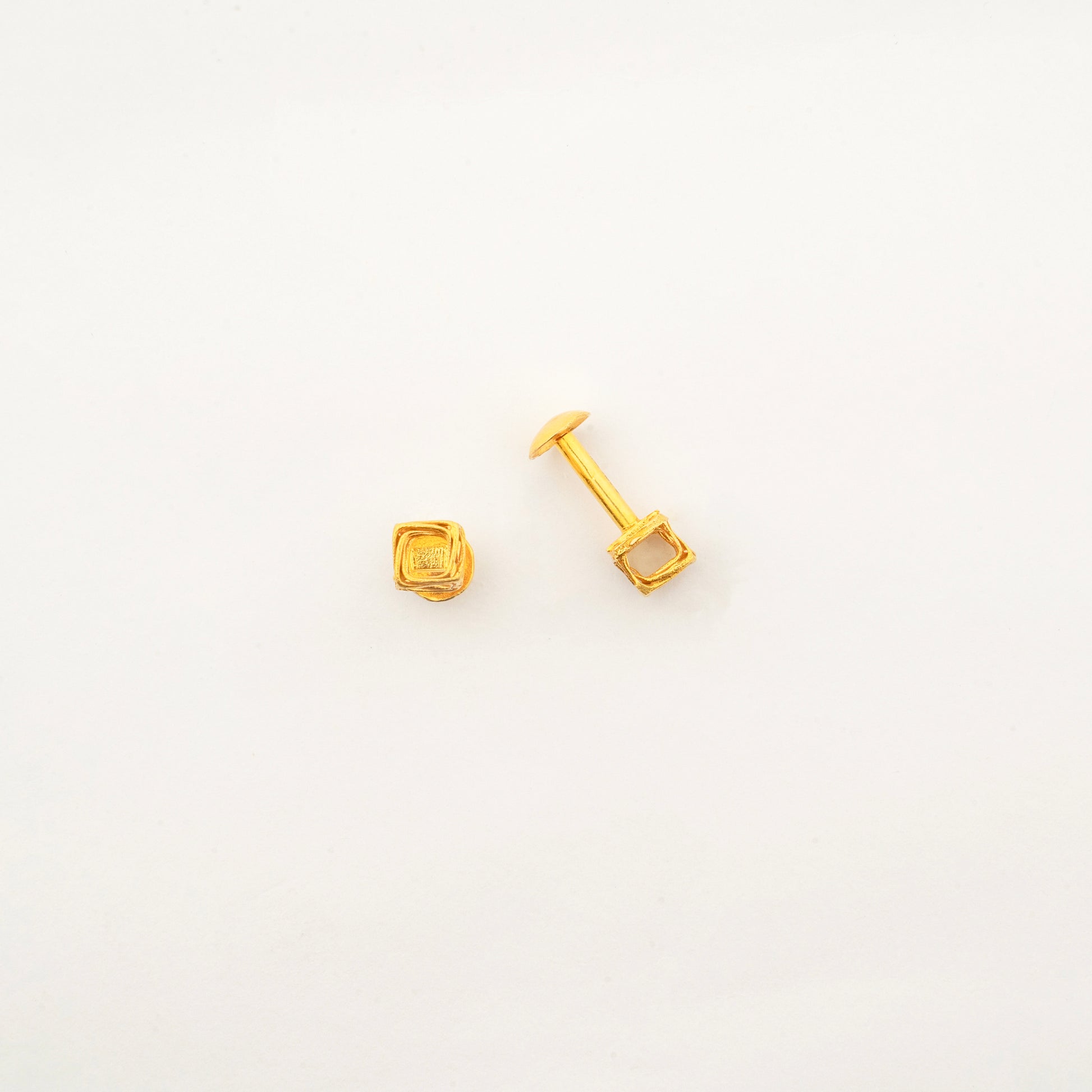 Sculptyx Vertex Vault Studs handcrafted in 18K gold featuring minimalist cube-shaped stud earrings with a polished geometric finish.